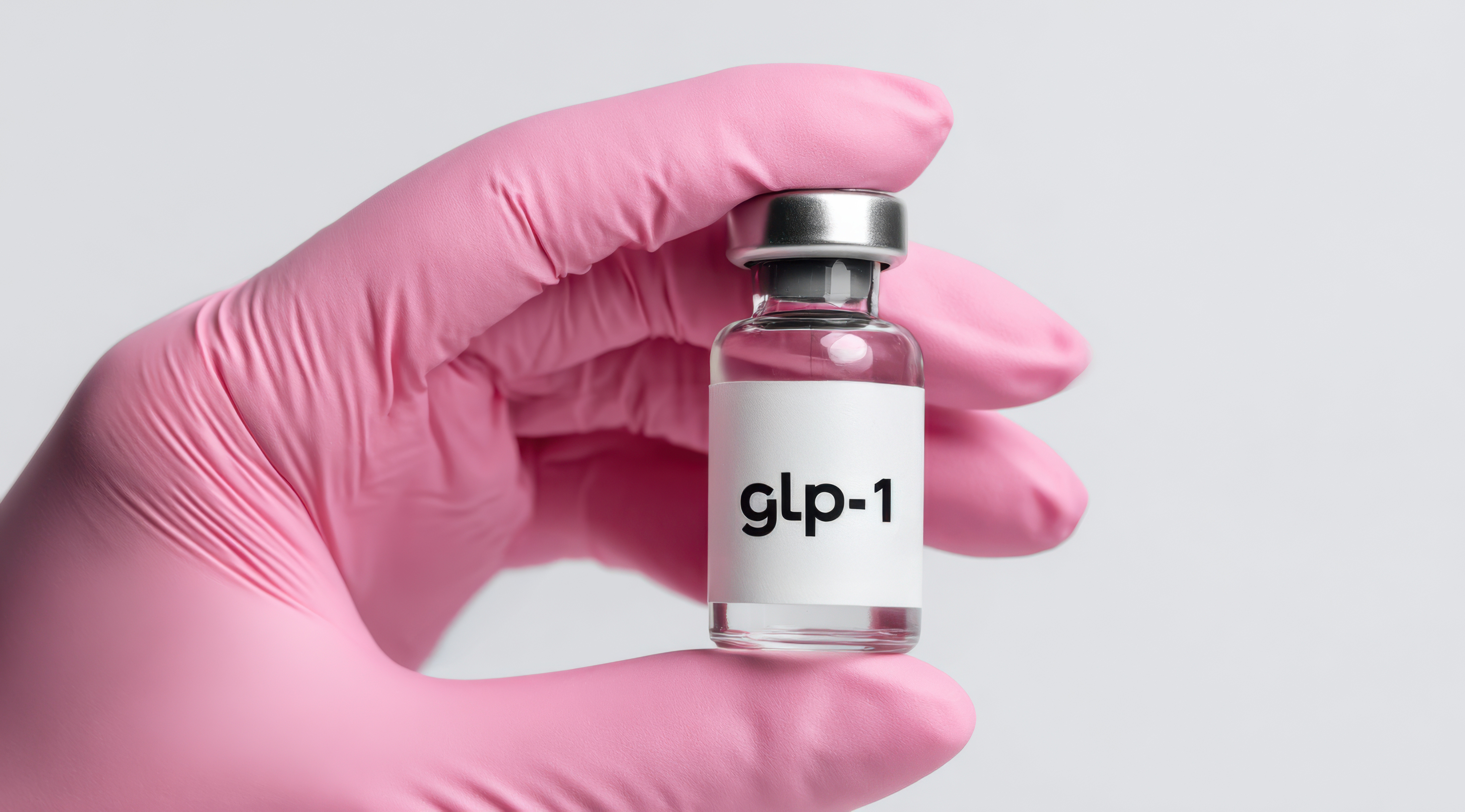 gloved hand holding GLP-1 vial