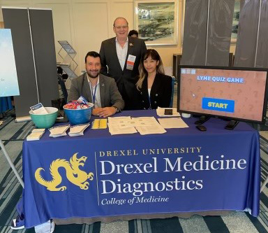 (standing) Garth Ehrlich, PhD, DMD's Technical Supervisor, President of the International Lyme and Associated Diseases Educational Foundation (ILADEF); (seated, left) Donald C. Hall, Jr. (DJ), PhD, DMD's Operations Director; (seated, right) Myat Thwe (Michiko), Dr. Ehrlich's graduate student; PhD student, School of Biomedical Engineering, Science and Health Systems